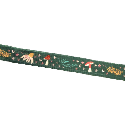 Decorative ribbon with mushroom and flower pattern on a white background